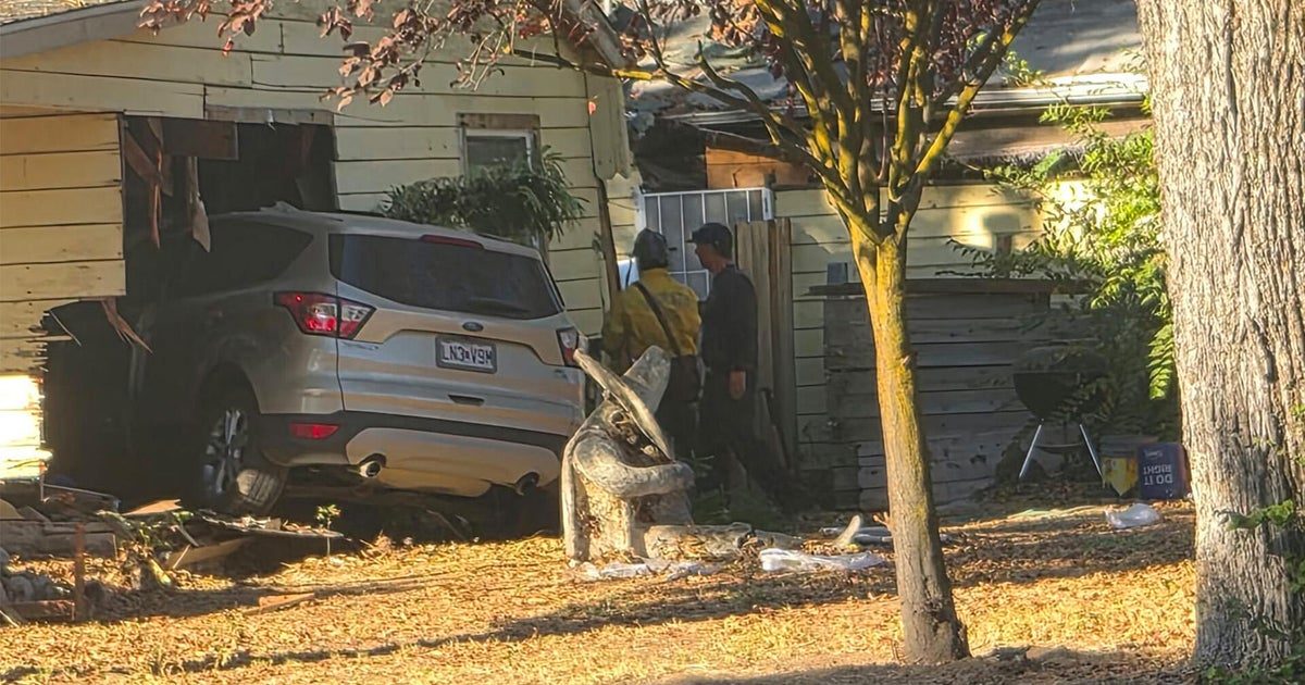 Modesto police investigate after vehicle crashes into home